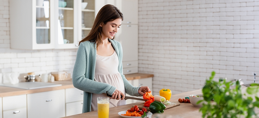 Pregnant woman eating nutritious foods for first trimester pregnancy nutrition