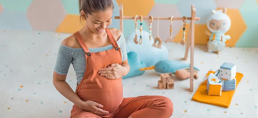 New mother holding her newborn baby, experiencing the fourth trimester changes and adjusting to postpartum life.