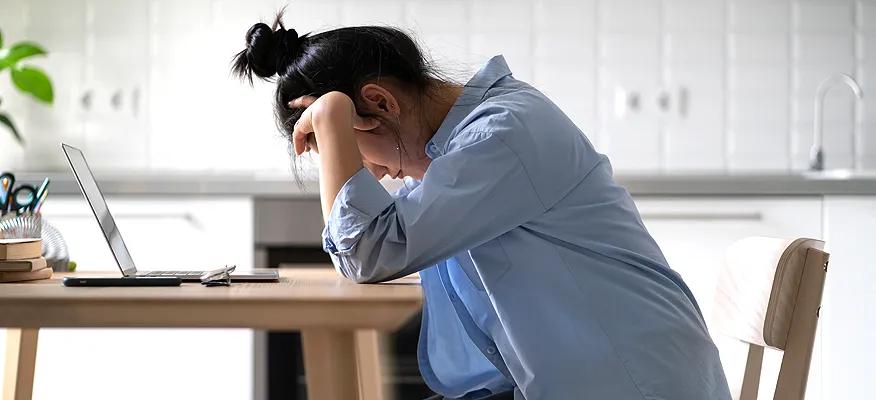 Person experiencing burnout, feeling mentally, emotionally, and physically exhausted at work.