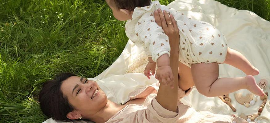 New mom holding baby, focusing on postpartum mental health and self-care strategies