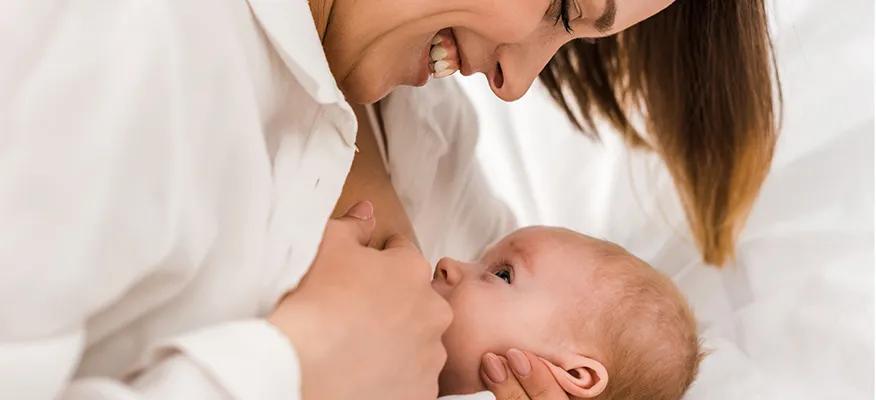 Nursing mother with baby - Managing nipple pain and infections during breastfeeding