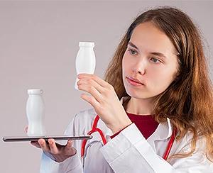 probiotics for diarrhea — doctor examining probiotic supplement bottles